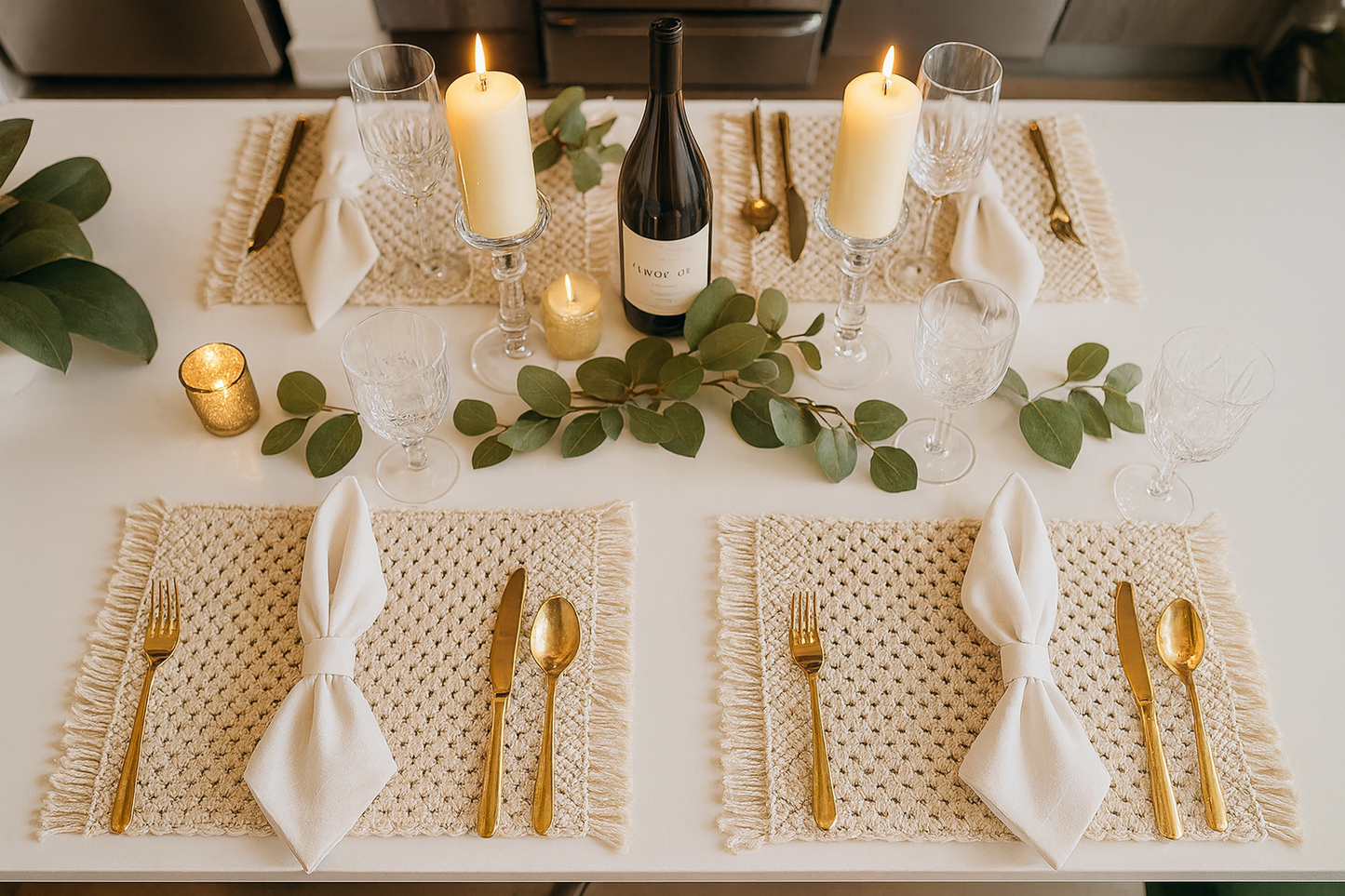 Elegant table setting with Boho macrame white rectangular placemats candles, wine, and gold cutlery on a white table.