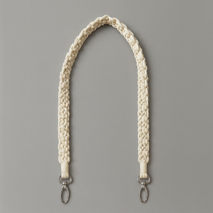 White braided boho macrame strap with metal hooks on a gray background
