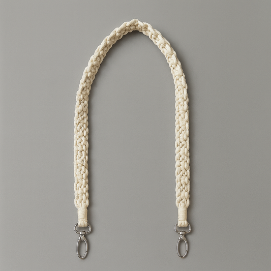 White braided boho macrame strap with metal hooks on a gray background